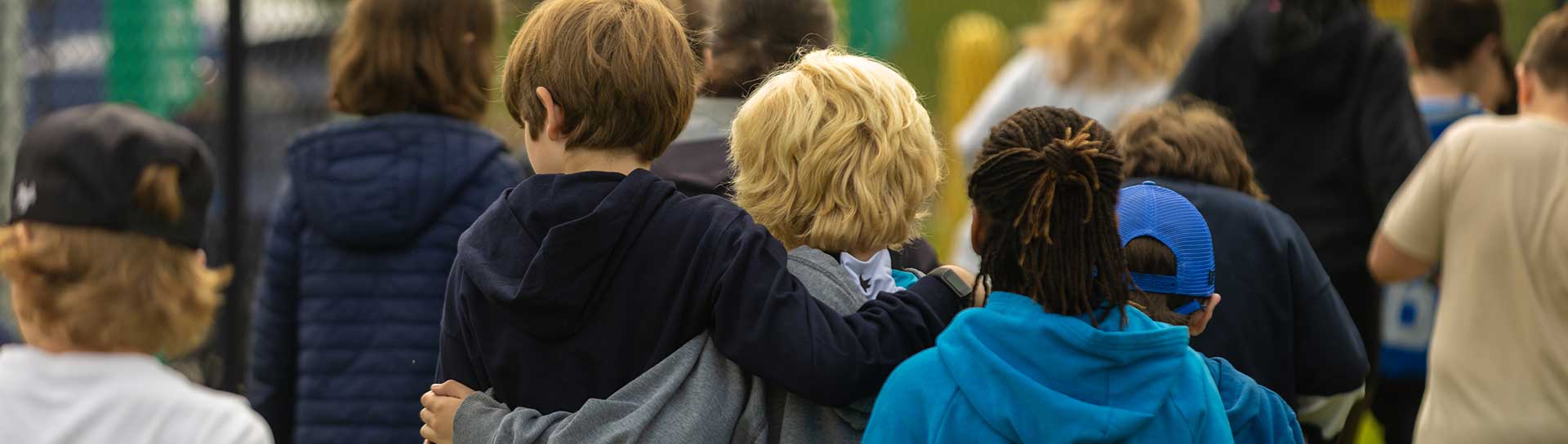 Kids walking arm in arm